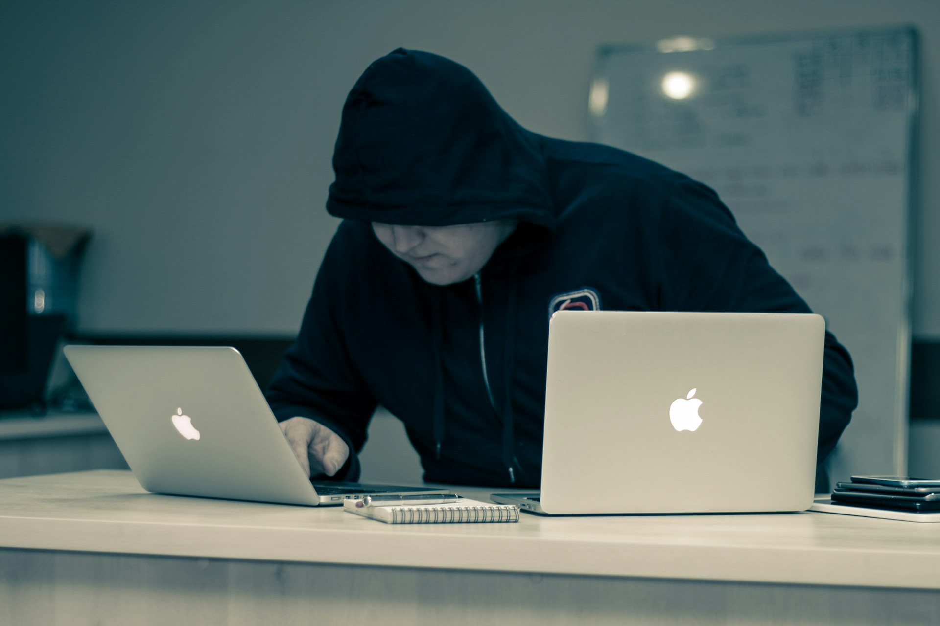 Man working on two laptops at the same time